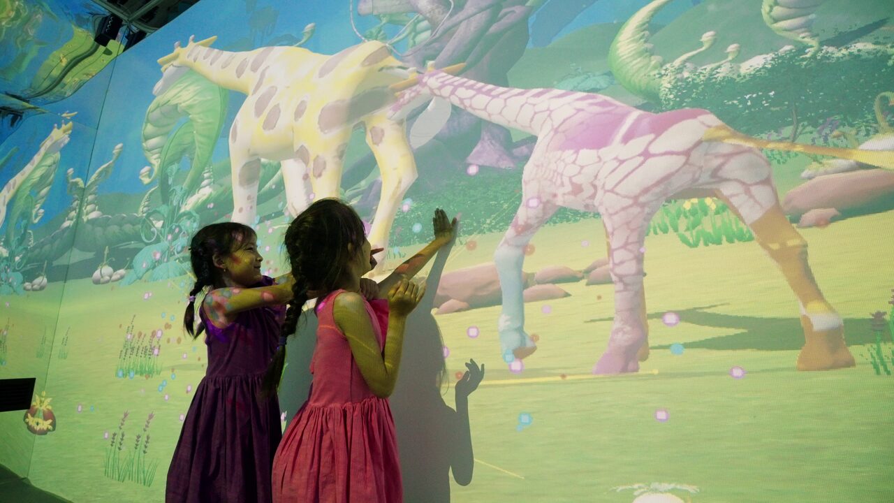 Children exploring an immersive projection savannah play world