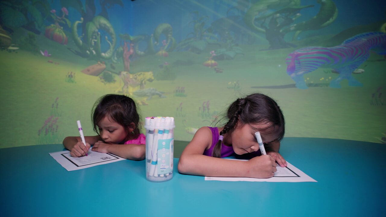 Kids colouring at the interactive immersive play table