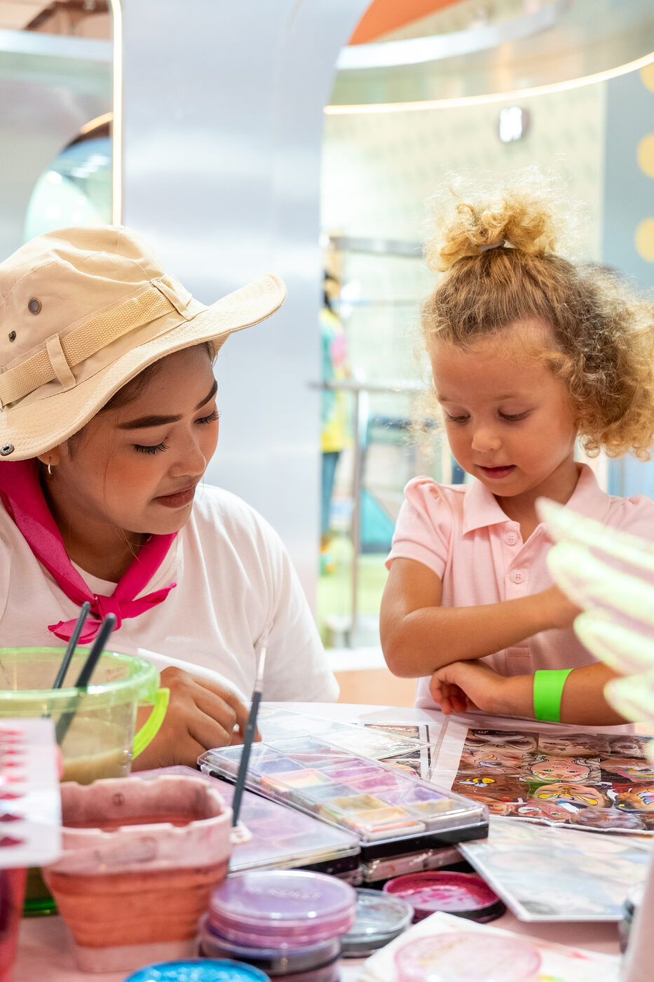 Nanny doing face paint and crafts with a little girl