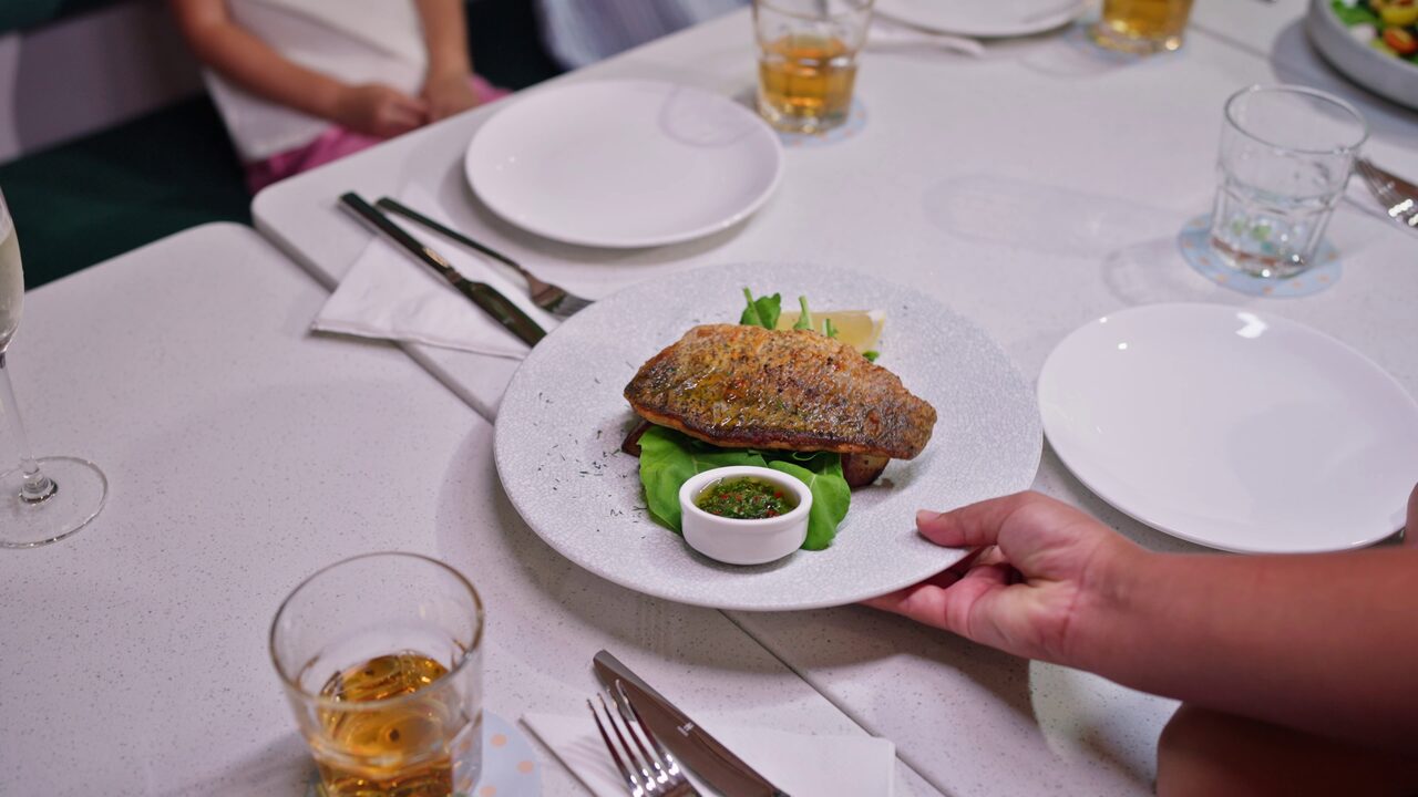 Crispy-skin fish fillet served at the table