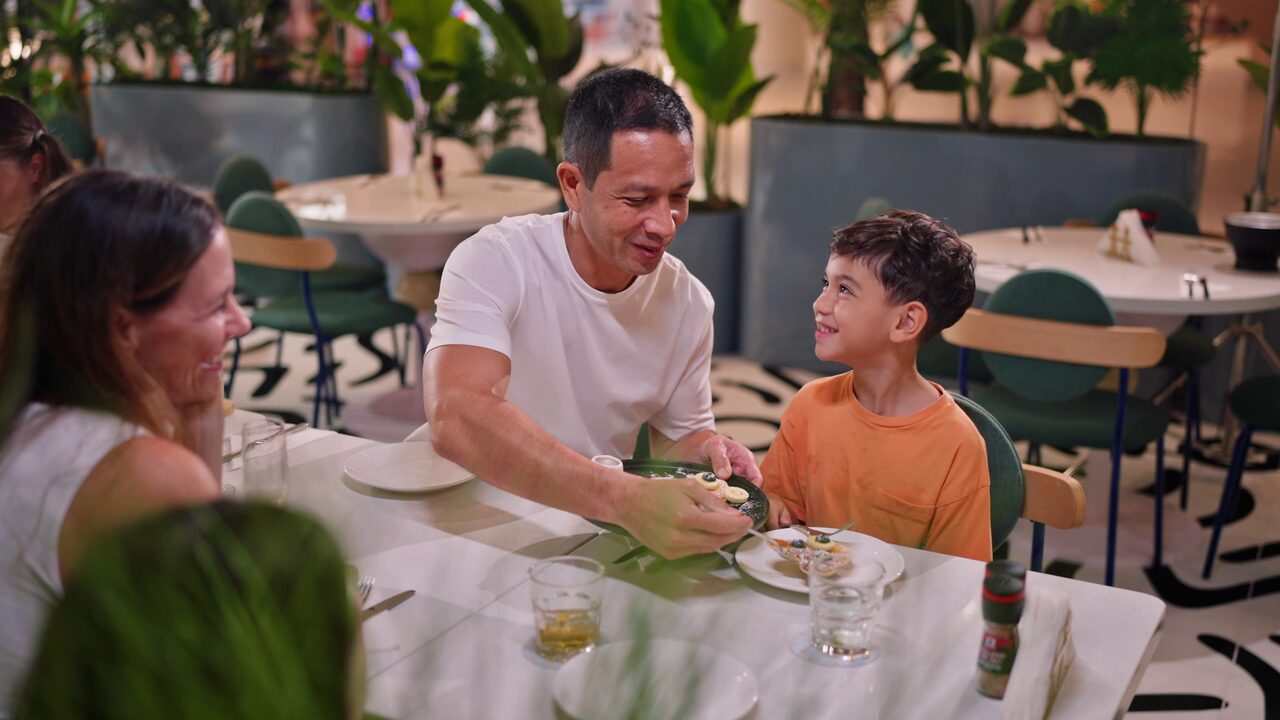 Father and son enjoying a meal at OTO