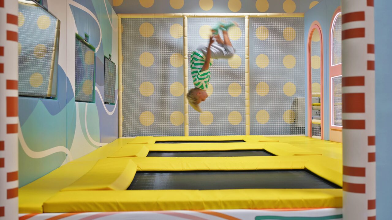 Child doing a flip on the trampolines